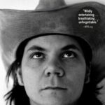 Black-and-white close-up of a man in a cowboy hat looking up. Text reads: Jeff Tweedy, Lets Go (So We Can Get Back): A Memoir of Recording and Discording with Wilco, Etc. and highlights its bestseller status.