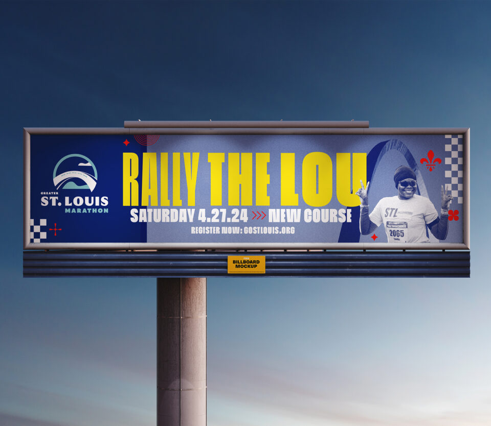 A billboard advertises the St. Louis Marathon with bold yellow and white text: Rally the Lou, Saturday 4.27.24, New Course. It features the marathon logo and a runner in sunglasses and a blue hat.