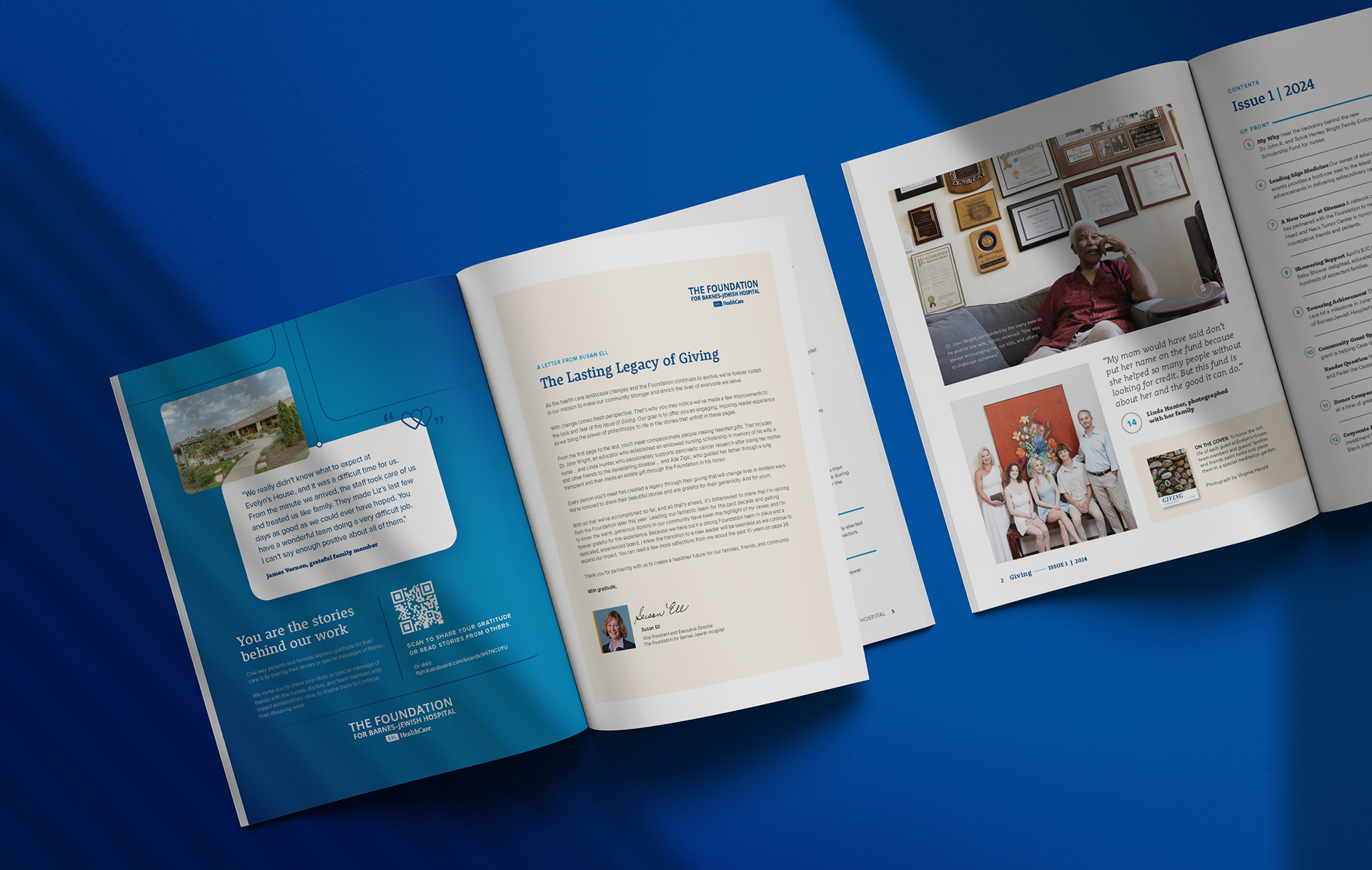 An open magazine on a blue surface displays articles, photos of people, and a letter. The left page features a message with an outdoor photo, while the right pages show a woman sitting and a group portrait.