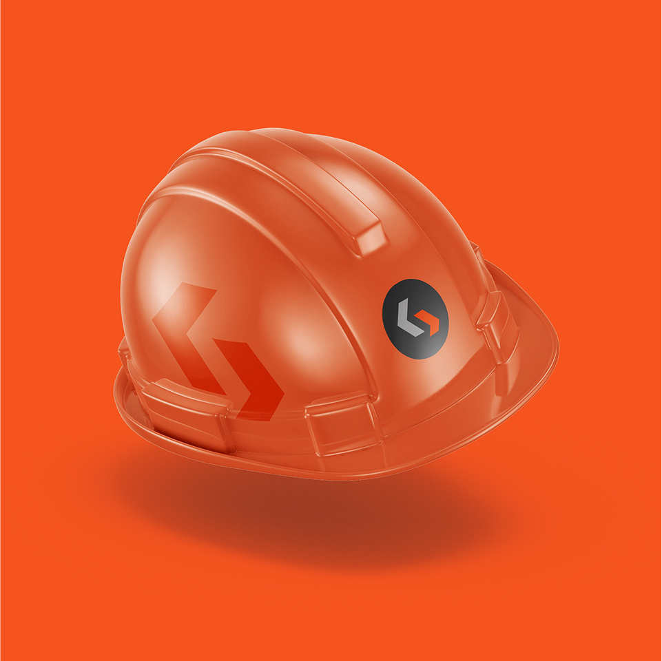 An orange construction hard hat with a black and orange logo and two angled arrows on the side, placed on an orange background.